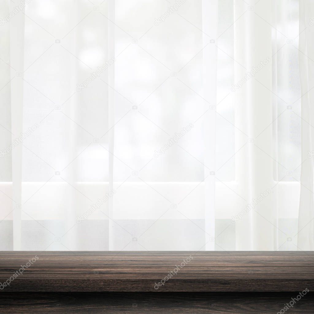 Empty of wooden table top on curtain and window background with blur of nature environment morning concept. Black wood table and space for place your product or design.