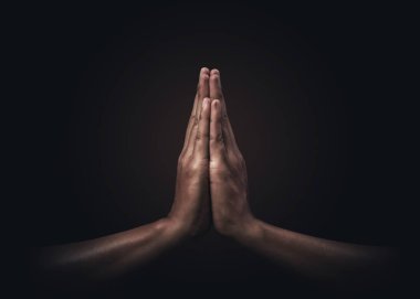 Praying hands with faith in religion and belief in God on dark background. Power of hope or love and devotion. Namaste or Namaskar hands gesture. Prayer position. clipart