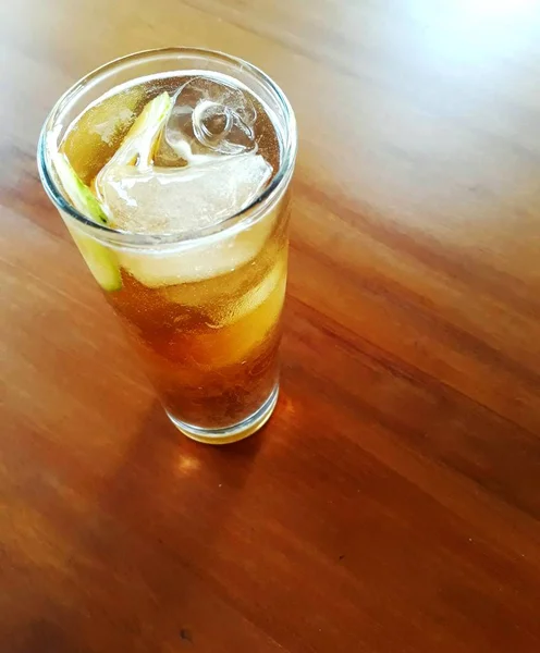 Kahverengi masa üzerinde Buz Çay uzun cam