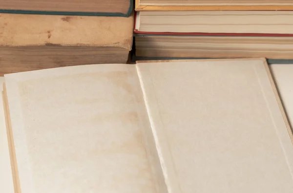Abrir libro viejo en blanco delante de la pila de libros — Foto de Stock