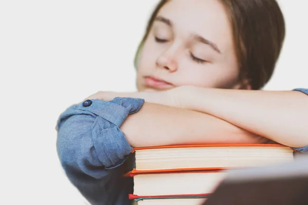 Stressed college student tired of hard learning with books in ex