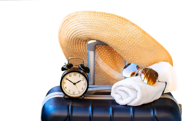 Summer time -Travel suitcase, straw hat, sunglasses and towel is