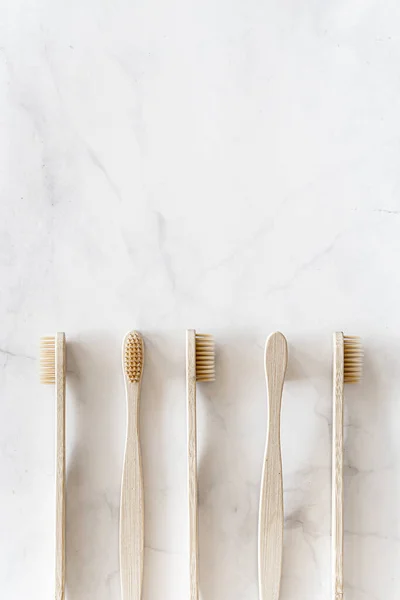 Eco friendly bamboo toothbrushes on marble background. — Stock Photo, Image