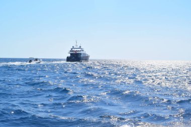 Yachts on the sparkling sea waves