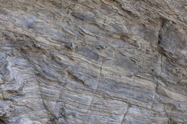 Doğal taş dokusu. Kaya yüzeyinin doğal dokusu, uzun süre çizilen çizgileri görebilirsiniz. Arka plan olarak kullanılabilir.