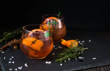 Negroni cocktail on black background served with a slice of orange and rosemary. Old cocktail classics. Italian aperitivo. clipart