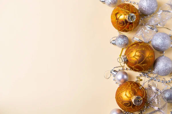 Golden and silver christmas balls decorations on yellow background with copy space for your text — Stock Photo, Image