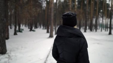 Mutlu kız parkta karda üfleme siyah kürk paltolu. Kış tatili. Mutlu kız kış Park portresi, o kar ile çalış.