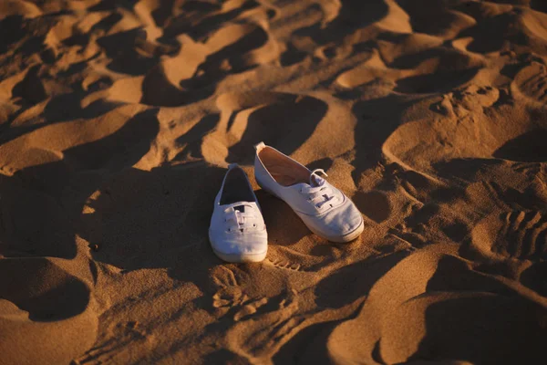 White shoes on the sand