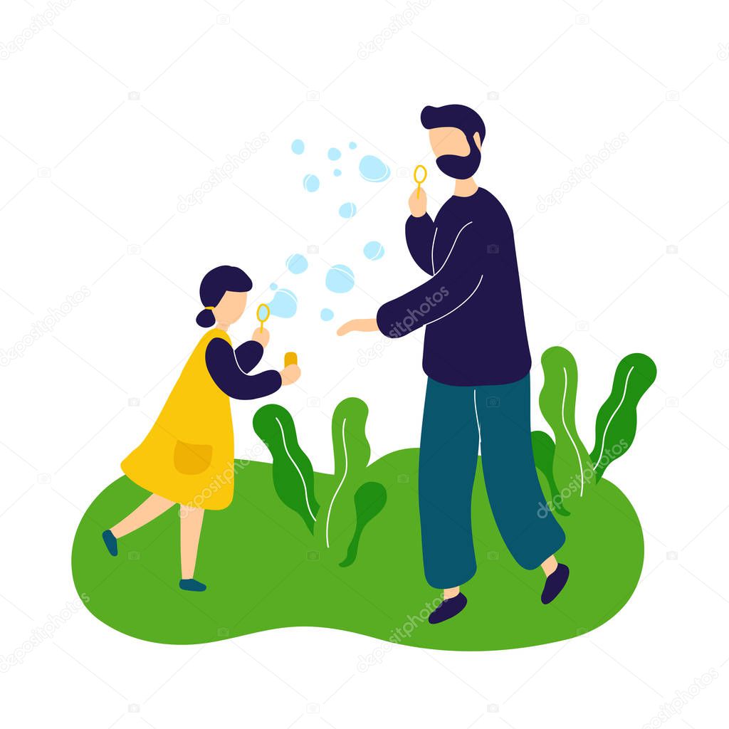 Father blowing soap bubbles with daughter outdoor