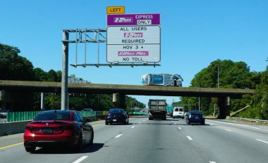Virginia, U.S.A - Sept 2, 2025 - Overhead sign indicates designated express lane, requiring E-ZPass for all users, including HOV 3+ and E-ZPass Flex users, with no toll collected.