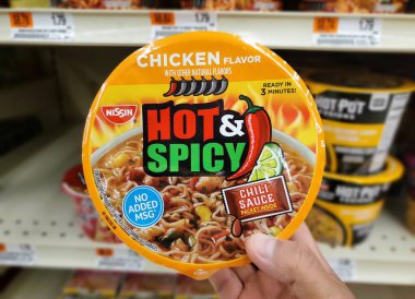 Wilmington, Delaware, U.S.A - Sept 16, 2025 - Nissin Hot and Spicy Chicken Flavor ramen, ready in 3 minutes, featuring a chili sauce packet.