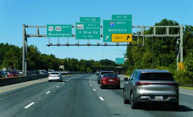 Maryland, U.S.A - Sept 10 2025 - Vehicles navigate Maryland highway, approaching I-97 North exit for Baltimore, Washington, Riva Road, and Aris T. Allen Blvd.