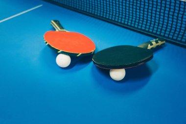 Masa tenisi kortunda iki raket.