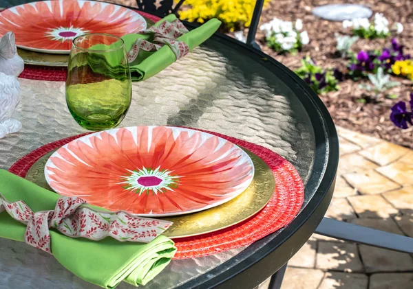 Table Setting - closeup. Interior and decorating ideas with this stack of dinner and salad plates on a Bright summer color-yellow, red, green, festive. Ready for a garden party, outdoor entertaining, brunch or special event.
