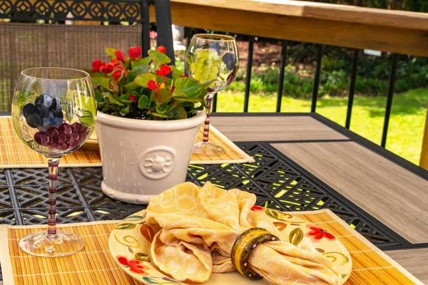 Table Setting - closeup. Interior and decorating ideas with this stack of dinner and salad plates on a Bright summer color-yellow, red, green, festive. Ready for a garden party, outdoor entertaining, brunch or special event.