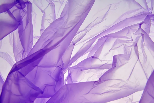 Plastik torba. Mor arka plan. Renk sıçraması. Sevgililer günü veya düğün için doku