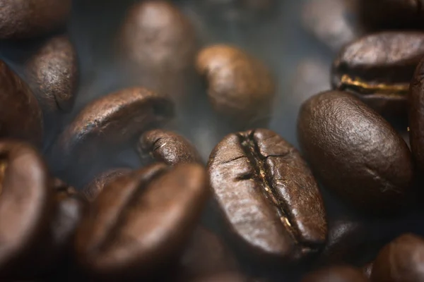 Different kinds of coffee beans. Coffee Background. Smoke roasted coffee beans.