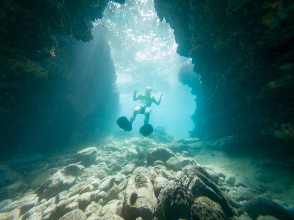 Nuoto subacqueo maschile attraverso tunnel subacquei naturali . — Foto Stock