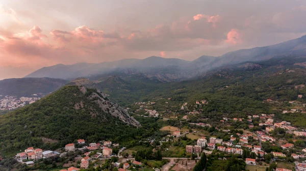 Spectacular aerial view of a town surrounded with hills. — Stock Photo, Image