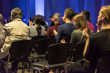 İş toplantısında konuşmacı seyirci alkışlar.