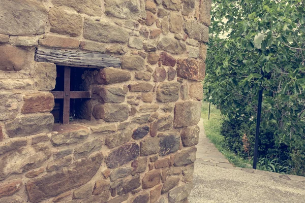 Detail of traditionaly built window in stone building with metal bars. — Stock Photo, Image