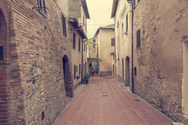 Cobble streets running through a medieval town. San Gimignano, Italy.
