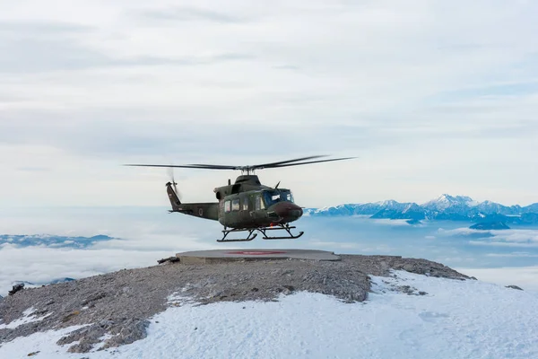 Mountain rescue helicopter landing to pick up wounded. — Stock Photo, Image