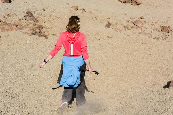 Sporty woman running down volcanic slope lifting dust trail. — Stock Photo, Image