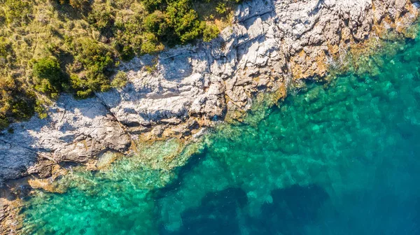 Spectacular aerial sea landscape of rocky coast and crystal clear water.