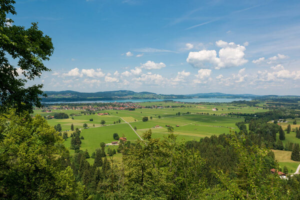 Panoramic view of riverland with green pastures and fields. Fussen region, Bavaria in Germany.