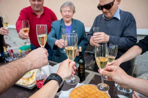 Firtst person point of view of celebrating and toasting with champagne.