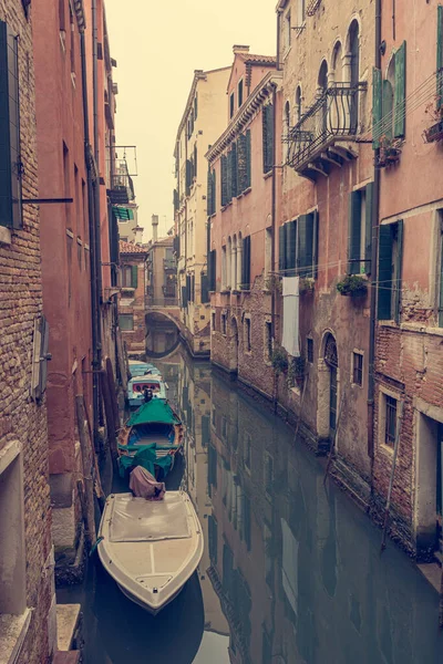 Narrow canal with boats parked ready for tourists.