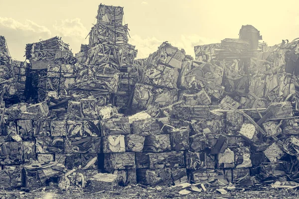 Compressed aluminium scrap in large cubes forming landfill in piles.