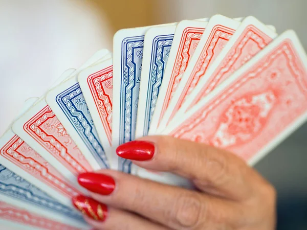 Playing cards with the back lined up in a woman\'s hand
