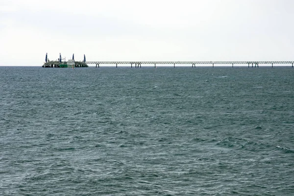 Long industrial bridge with pier — Stock Photo, Image