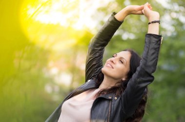 Beautiful middle-age woman in black leather jacket enjoying life.