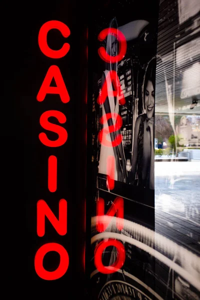 Casino sign with reflection on the window. Urban style, concept
