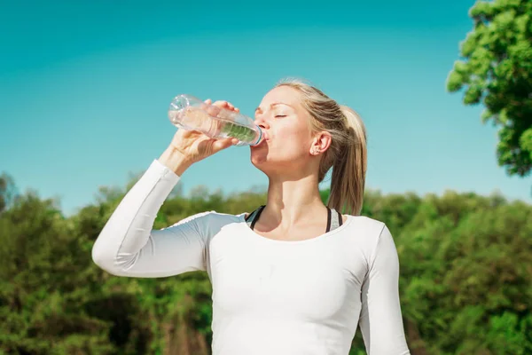 Rubia, fuerte ajuste, mujer deportiva beber agua después de su entrenamiento — Foto de Stock