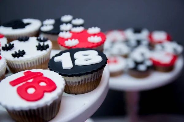 Delicious red and black chocolate cupcakes with 18 number on top of them. — Stock Photo, Image