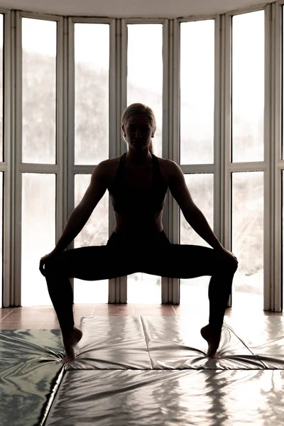 Beautiful woman coach yoga practice. Yoga concept. Sumo squat pose