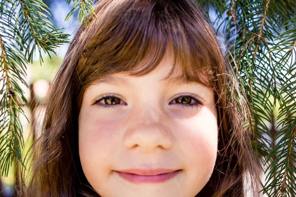 Retrato de cerca de la pequeña morena con los ojos marrones sonriendo . —  Fotos de Stock