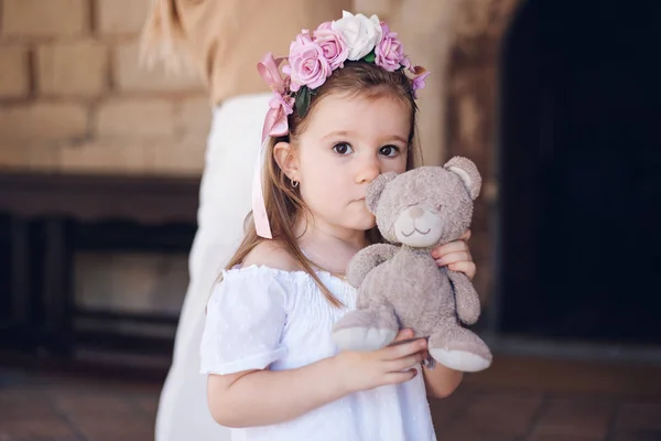 Linda chica mostrando su amigo imaginario osito de peluche. Día internacional de los niños —  Fotos de Stock