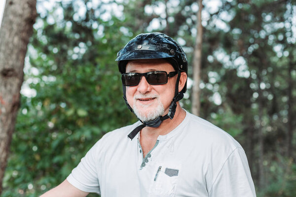 Middle aged man wearing his helmet for a motor bike ride.