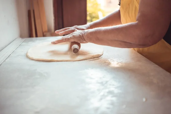 Female hands using dough roller. Process of making croissant rolls — Stock Photo, Image