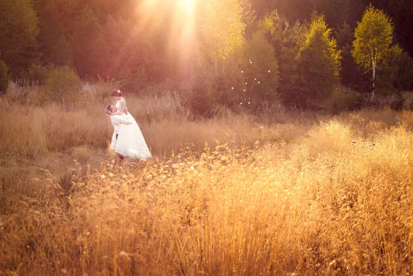 Happy married couple. Outdoors photos in golden hour, afternoon, warm light