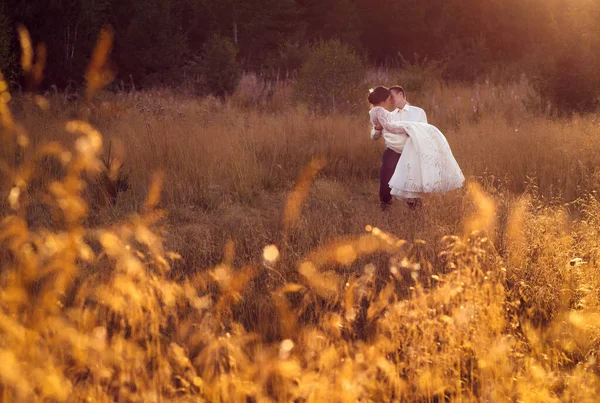 Happy married couple. Outdoors photos in golden hour, afternoon, warm light