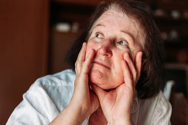 Close Retrato Uma Mulher Idosa Sentada Cadeira Mãos Cabeça Parecendo — Fotografia de Stock