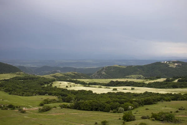 Mountain valley landscape. Mountains in the panorama valley. View of flower fields in a mountain valley.