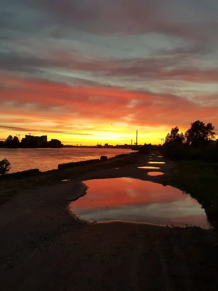 ネヴァ川の夕日の美しい景色 空の黄色 ピンクの色が水たまりに反映されます — ストック写真